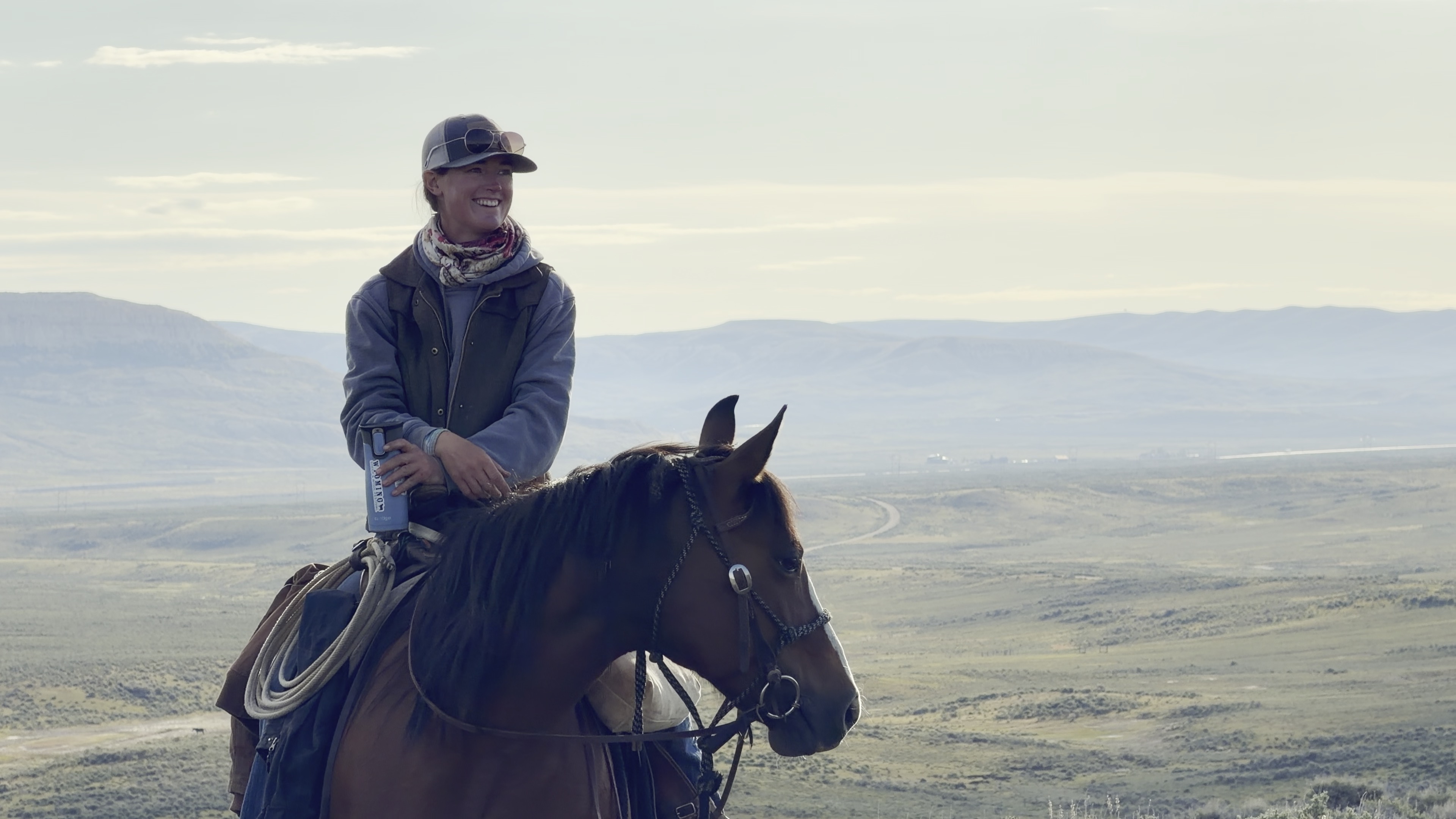 Marie McClaren sitting on horseback above a Wyoming rangeland
